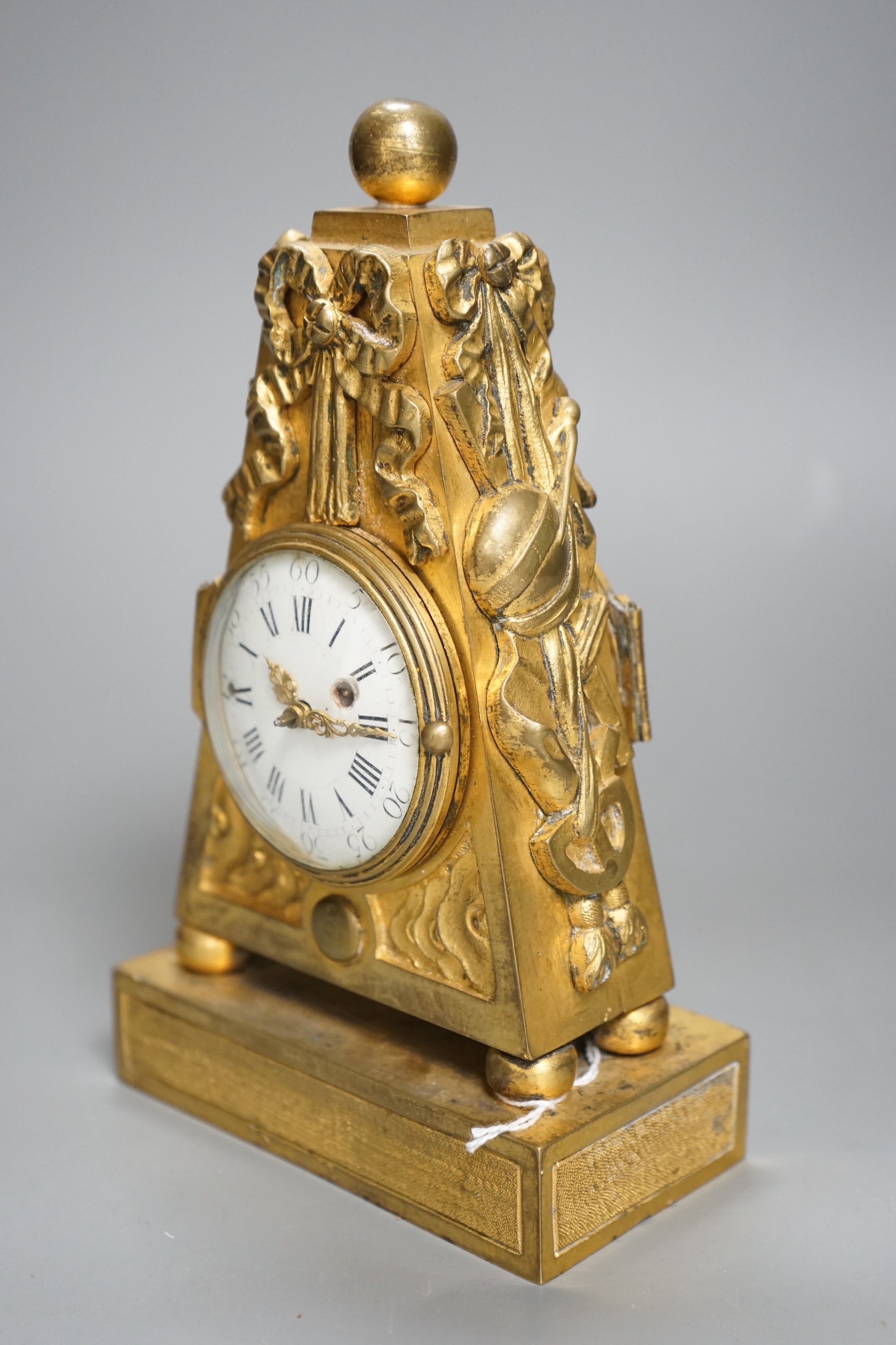 An 18th century French ormolu mantle timepiece with convex enamelled dial, 20cm
